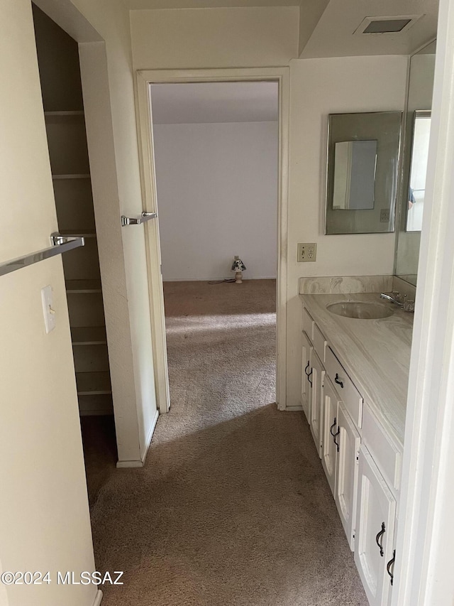 bathroom with visible vents, carpet floors, and vanity