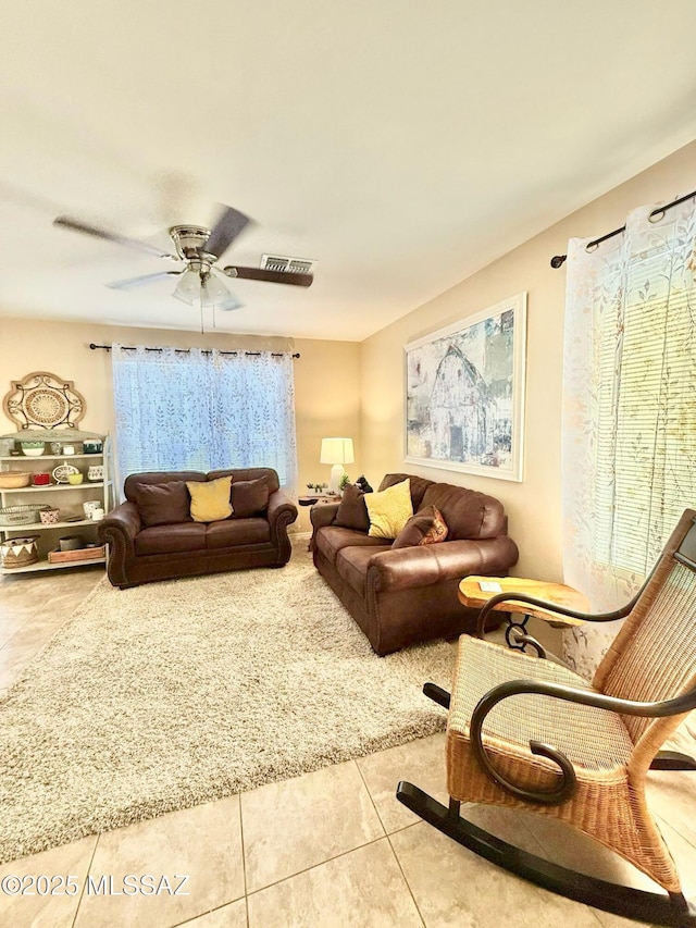living room with ceiling fan, tile patterned flooring, and visible vents