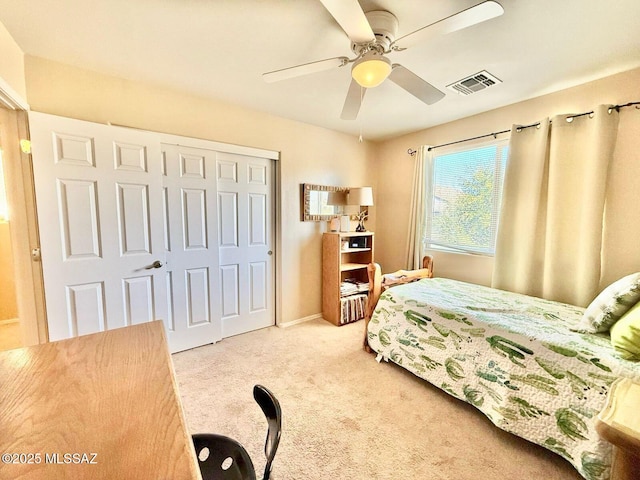 bedroom with visible vents, baseboards, a closet, a ceiling fan, and carpet flooring