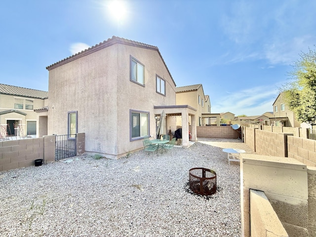back of property featuring a patio area, stucco siding, a fenced backyard, and a tile roof