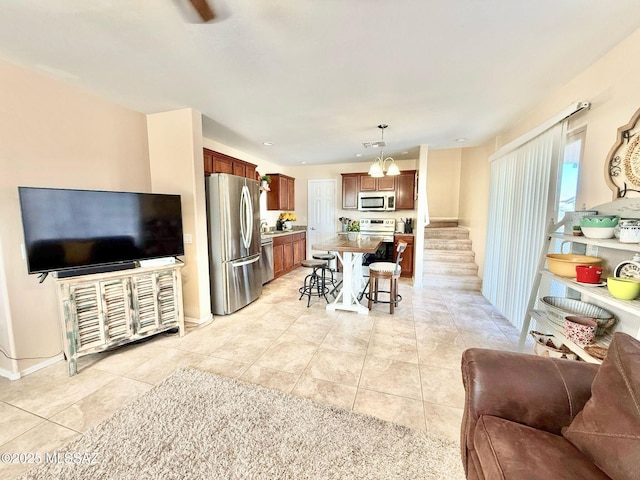 living room with light tile patterned floors and stairs