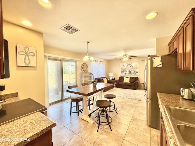 dining space with visible vents, a ceiling fan, light tile patterned flooring, and recessed lighting