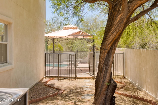 view of yard featuring fence and a gazebo