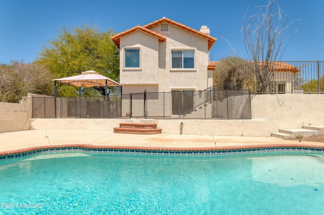 view of swimming pool featuring a fenced in pool, a fenced backyard, and a patio area
