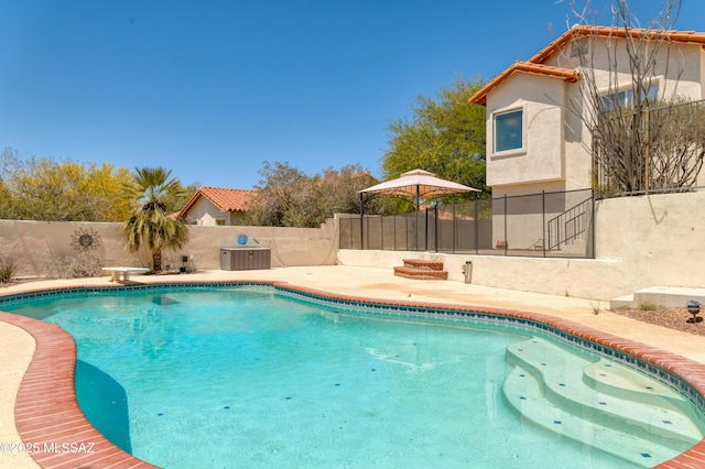 view of swimming pool featuring a fenced in pool, a fenced backyard, a diving board, and a patio