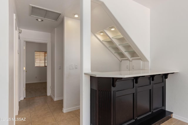 interior space with visible vents, recessed lighting, baseboards, and light tile patterned floors