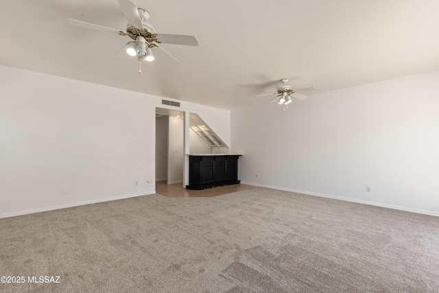 unfurnished living room featuring ceiling fan, visible vents, light carpet, and baseboards