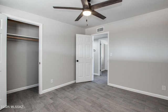 unfurnished bedroom with visible vents, wood finished floors, a closet, baseboards, and ceiling fan