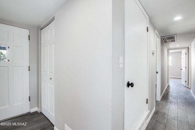 hall featuring recessed lighting, visible vents, baseboards, and dark wood-style floors