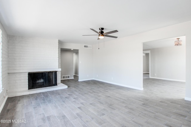 unfurnished living room featuring visible vents, wood finished floors, baseboards, and ceiling fan