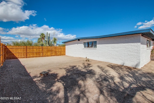 view of side of home featuring a fenced backyard