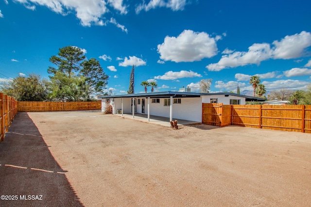 rear view of house featuring a patio and a fenced backyard