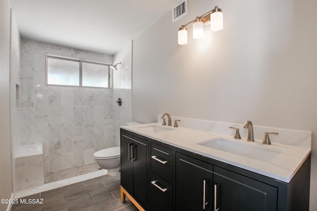 full bathroom featuring a sink, visible vents, and tiled shower