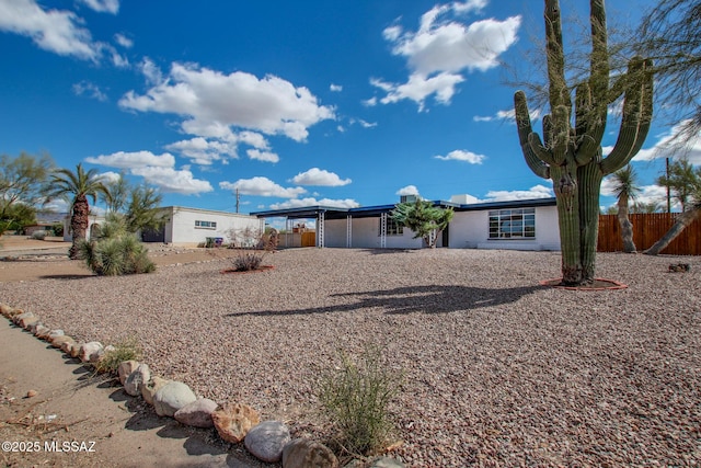 exterior space featuring fence, a garage, and driveway