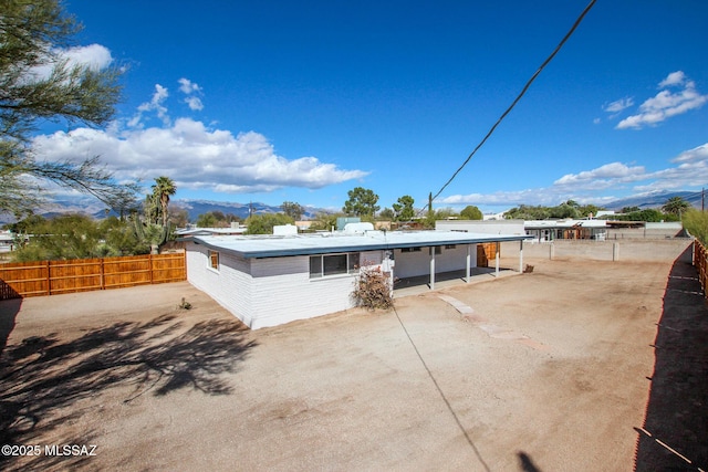 rear view of house with a patio and fence