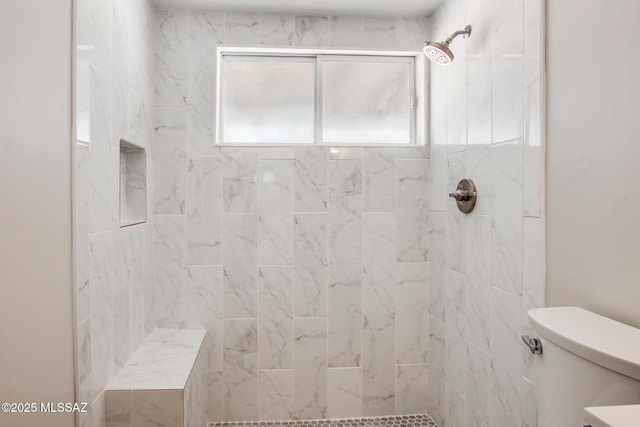 full bath with toilet, a healthy amount of sunlight, and tiled shower