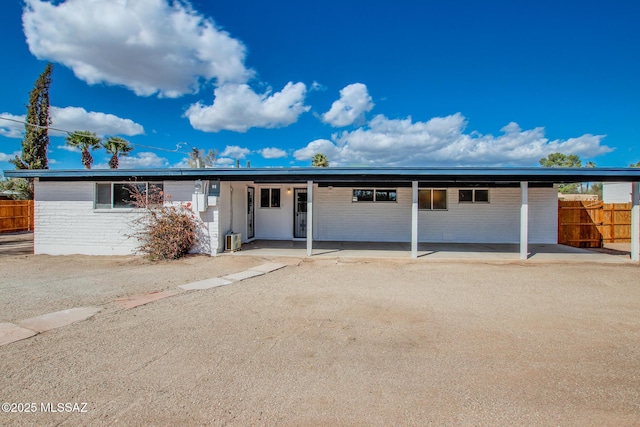 ranch-style home with brick siding and fence