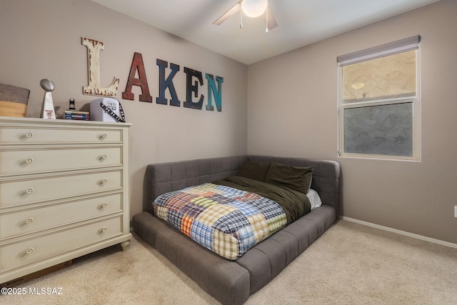 bedroom with light carpet, a ceiling fan, and baseboards