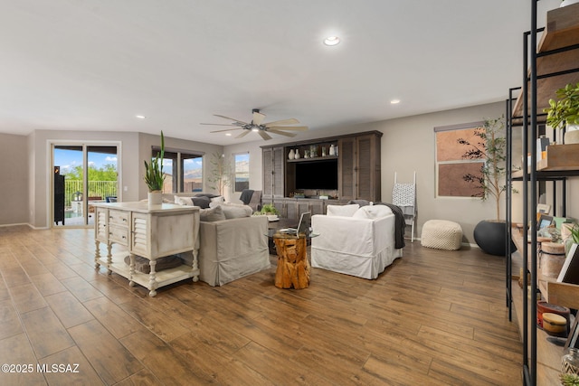 living room with ceiling fan, baseboards, wood finished floors, and recessed lighting