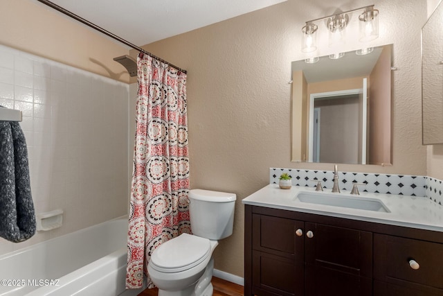 full bath with vanity, toilet, shower / tub combo with curtain, and a textured wall