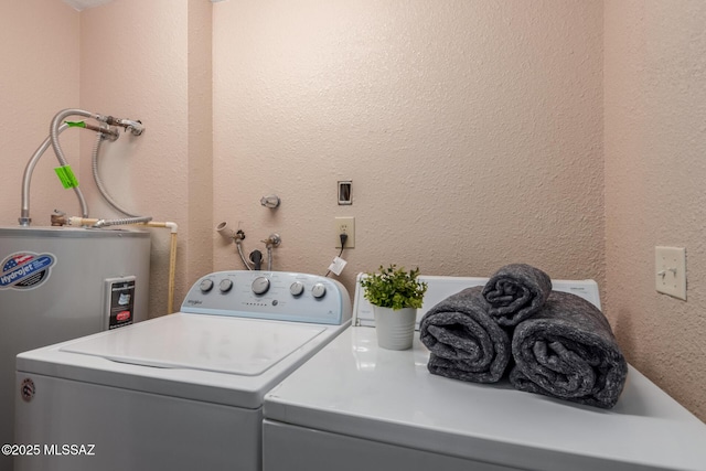 laundry area with washer and dryer, laundry area, a textured wall, and water heater