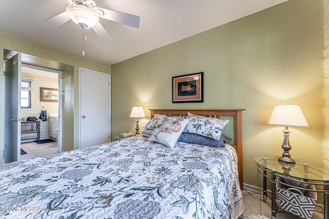 bedroom with tile patterned floors, ensuite bath, and a ceiling fan