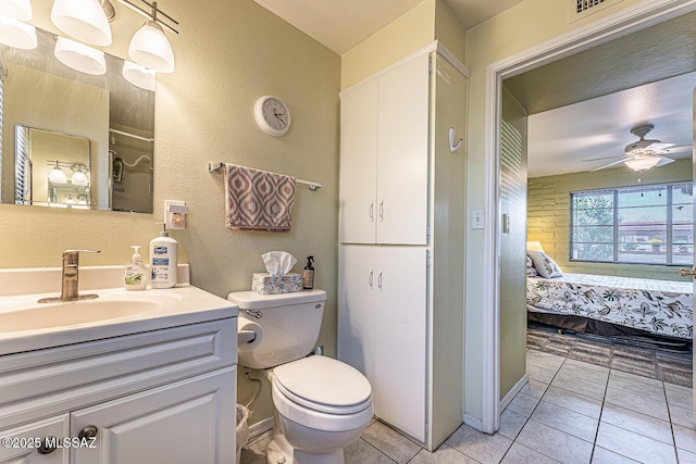 bathroom featuring toilet, vanity, tile patterned floors, ensuite bath, and a ceiling fan