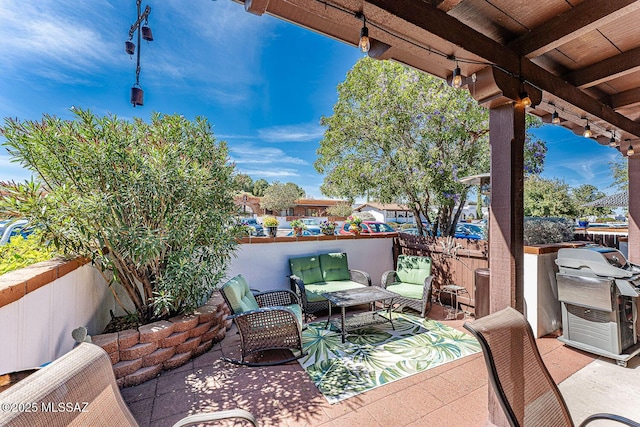 view of patio with an outdoor living space, fence, and a grill