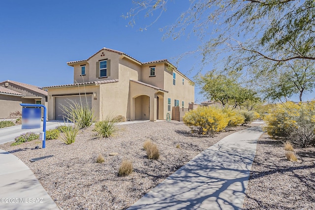 view of front of house with a tiled roof, a garage, driveway, and stucco siding