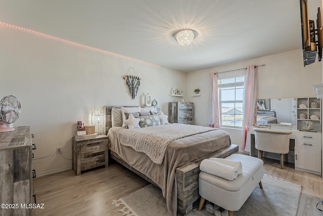 bedroom featuring light wood-style flooring and baseboards
