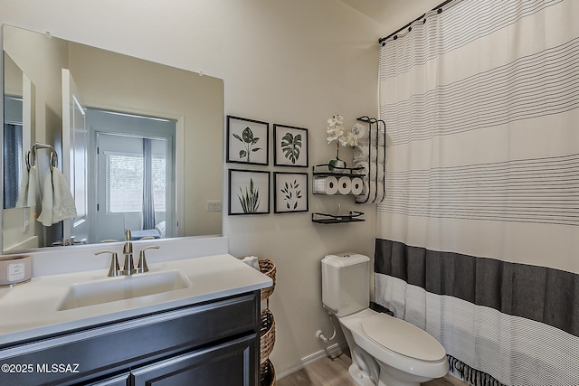 full bath with vanity, toilet, wood finished floors, and baseboards