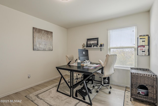 office area featuring light wood-style flooring and baseboards