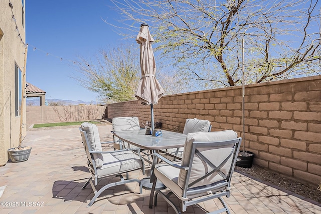 view of patio with outdoor dining area and a fenced backyard
