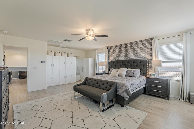 bedroom featuring visible vents, light wood-type flooring, and ceiling fan