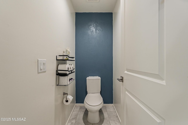 bathroom with tile patterned floors, visible vents, toilet, and baseboards