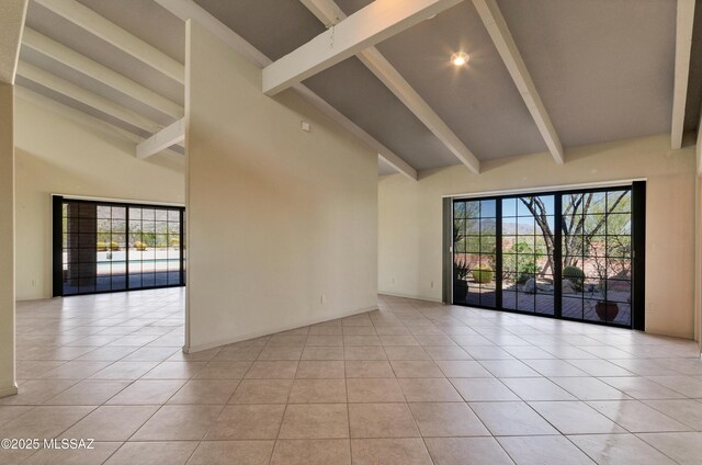 5460 N Paseo Pescado, Tucson, AZ 85718 - unfurnished room featuring beam ceiling, high vaulted ceiling, light tile patterned flooring, and plenty of natural light