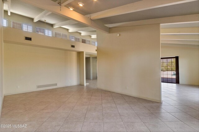 5460 N Paseo Pescado, Tucson, AZ 85718 - spare room with beam ceiling, light tile patterned flooring, and plenty of natural light