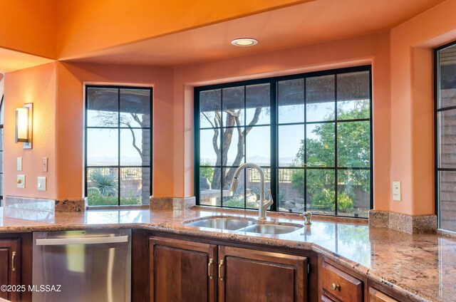 5460 N Paseo Pescado, Tucson, AZ 85718 - kitchen with stainless steel dishwasher, plenty of natural light, and light stone counters
