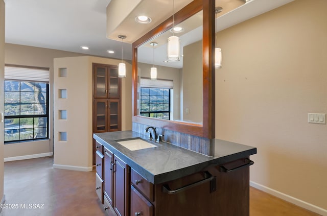 5460 N Paseo Pescado, Tucson, AZ 85718 - kitchen with baseboards, dark countertops, a sink, and a healthy amount of sunlight