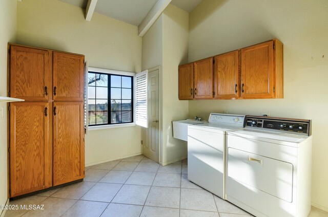 5460 N Paseo Pescado, Tucson, AZ 85718 - laundry room with cabinet space, a high ceiling, independent washer and dryer, and light tile patterned floors