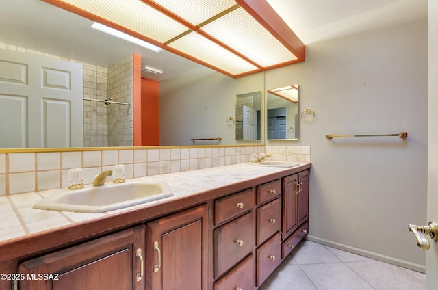 5460 N Paseo Pescado, Tucson, AZ 85718 - bathroom featuring double vanity, tile patterned flooring, decorative backsplash, and a sink