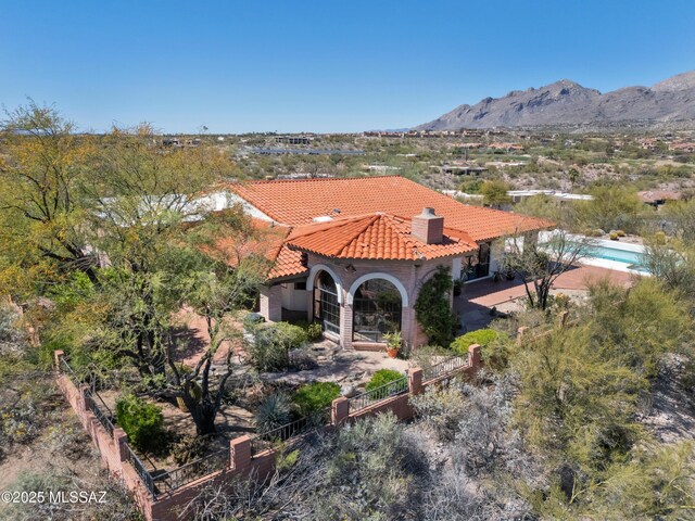 5460 N Paseo Pescado, Tucson, AZ 85718 - view of front of property featuring a tile roof, a chimney, a mountain view, and stucco siding
