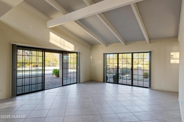 5460 N Paseo Pescado, Tucson, AZ 85718 - empty room featuring beamed ceiling, healthy amount of natural light, light tile patterned floors, and high vaulted ceiling
