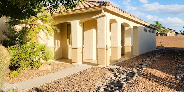 view of outbuilding featuring fence