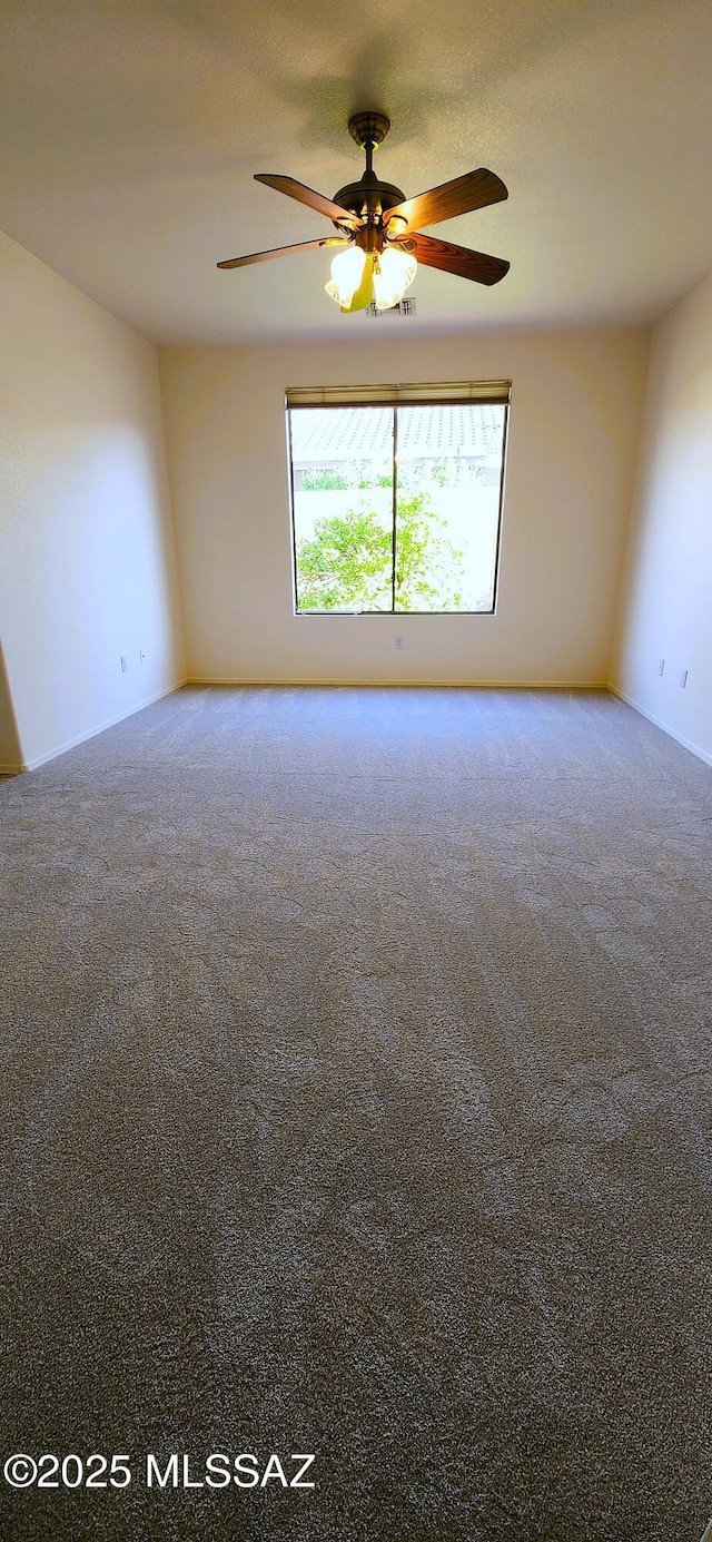 empty room featuring carpet and ceiling fan