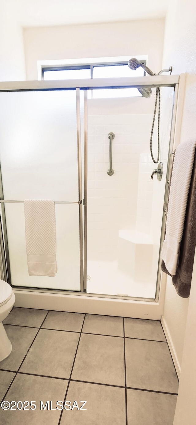 bathroom featuring a stall shower, tile patterned floors, and plenty of natural light