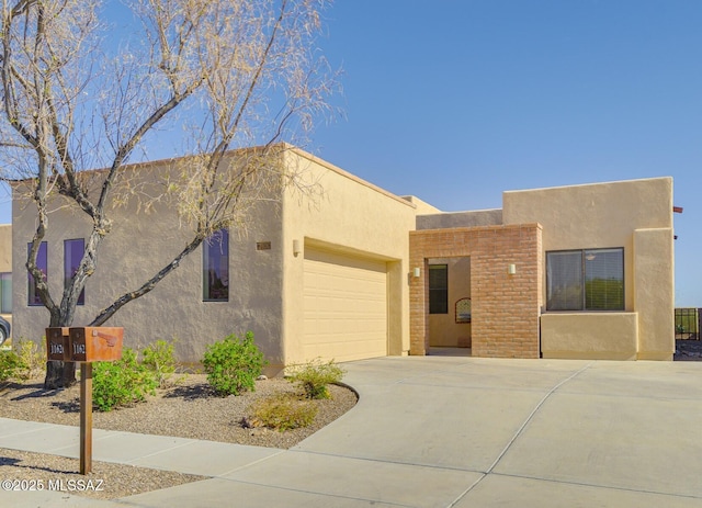 11626 N Moon Ranch Pl, Marana, AZ 85658 - pueblo-style house featuring an attached garage, driveway, and stucco siding