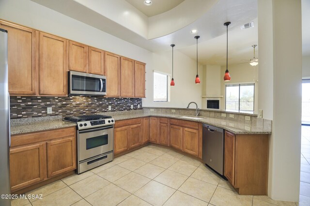 11626 N Moon Ranch Pl, Marana, AZ 85658 - kitchen featuring visible vents, a sink, appliances with stainless steel finishes, brown cabinetry, and ceiling fan