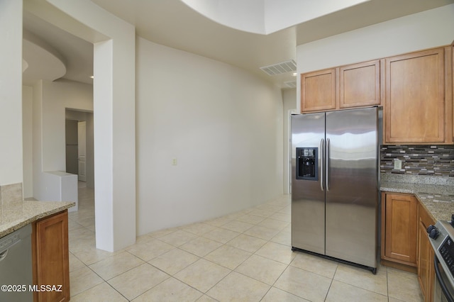 11626 N Moon Ranch Pl, Marana, AZ 85658 - kitchen featuring visible vents, dishwasher, decorative backsplash, stove, and stainless steel fridge