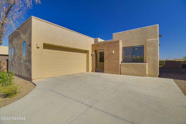 11626 N Moon Ranch Pl, Marana, AZ 85658 - adobe home with stucco siding, a garage, driveway, and fence